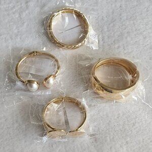 Four assorted gold-toned fashion bracelets